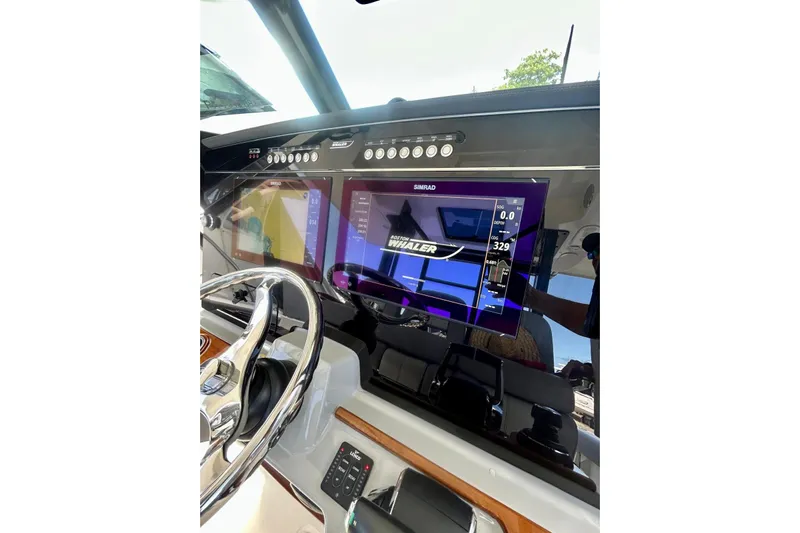  Yacht Photos Pics 2023 Boston Whaler 360 Outrage dashboard with Simrad display and steering wheel.