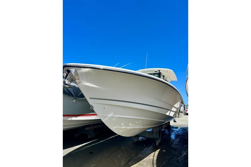  Yacht Photos Pics 2023 Boston Whaler 360 Outrage boat under clear blue sky.