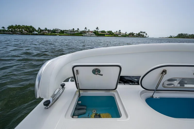 It's Time Yacht Photos Pics 2015 Bahama 41 boat with open storage compartments on a calm waterway.