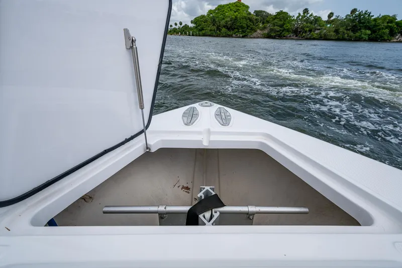 It's Time Yacht Photos Pics Open storage compartment on 2015 Bahama 41 boat, with scenic water and trees in background.