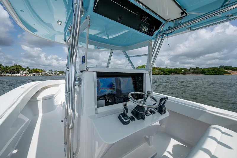 It's Time Yacht Photos Pics 2015 Bahama 41 boat cockpit with modern navigation equipment, steering wheel, and ocean view.