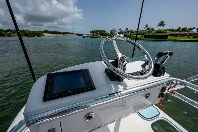 It's Time Yacht Photos Pics Helm of 2015 Bahama 41 boat with steering wheel and navigation screen.