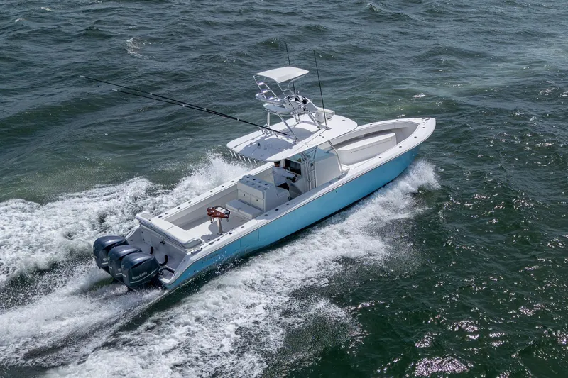 It's Time Yacht Photos Pics 2015 Bahama 41 boat cruising on open water, featuring triple outboard engines.