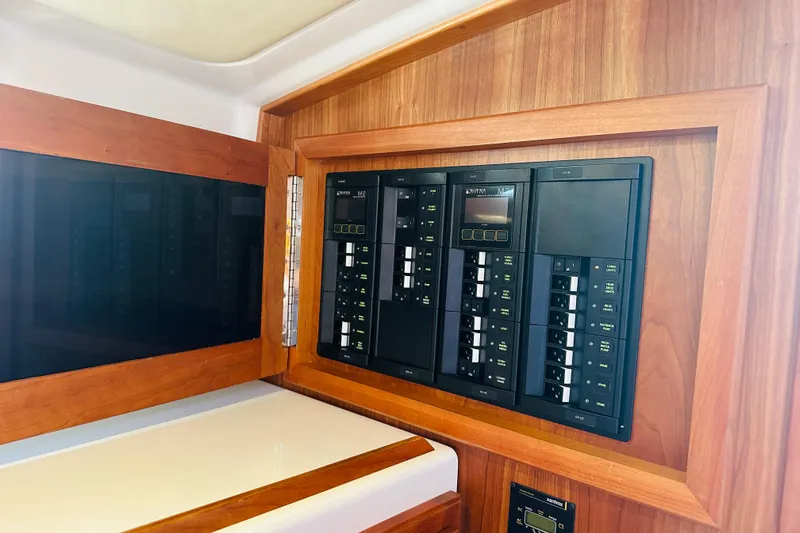 Watermark Yacht Photos Pics Electrical panel on 2017 Back Cove 32 boat, featuring wooden trim and control switches.
