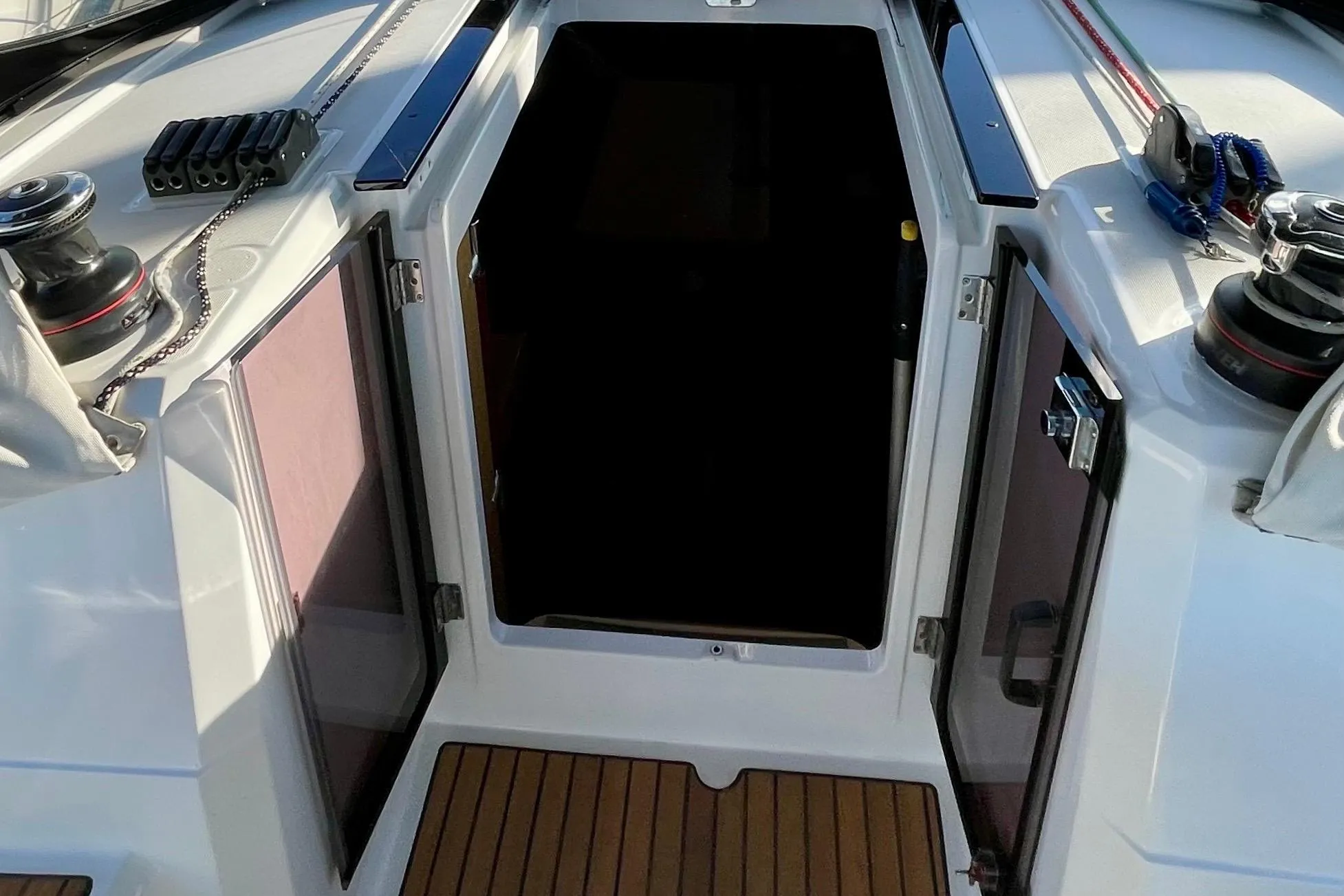 Beneteau First 235 sailboat cockpit entrance, 2015 model, with open doors and winches.
