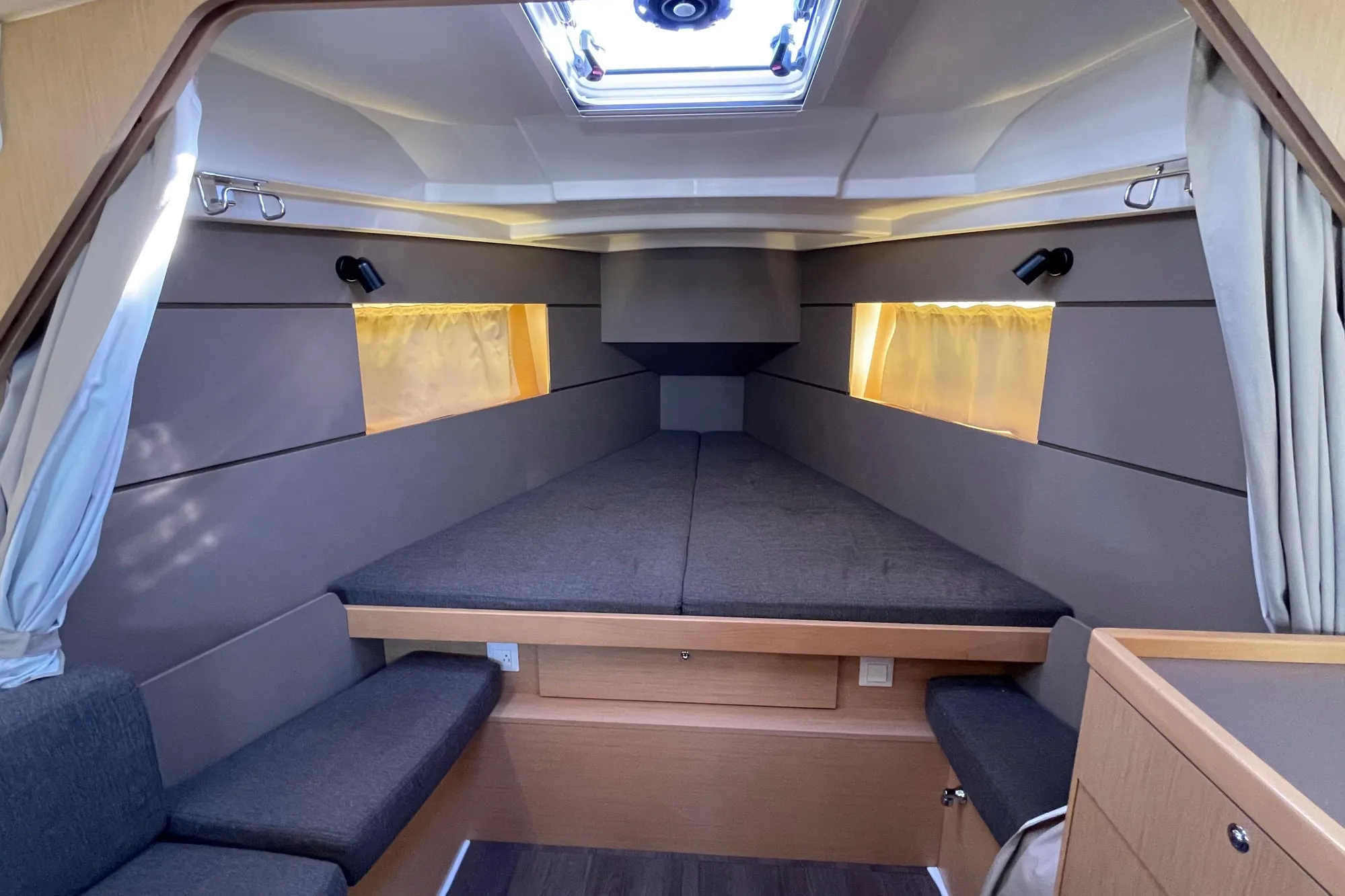 Cozy interior of 2015 Beneteau First 235 sailboat with modern design and comfortable seating.