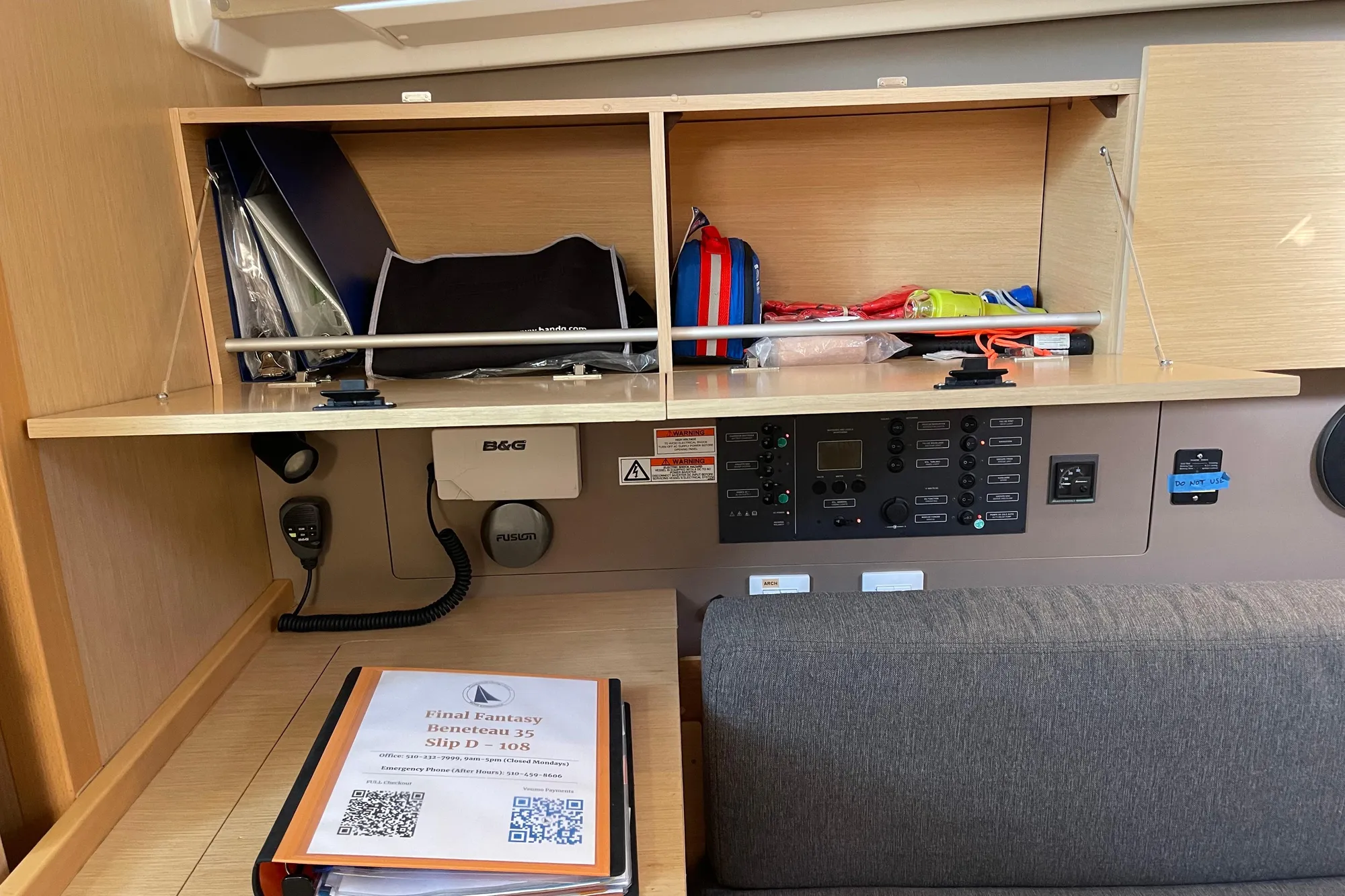Interior of a 2015 Beneteau First 235 sailboat with navigation equipment and storage.