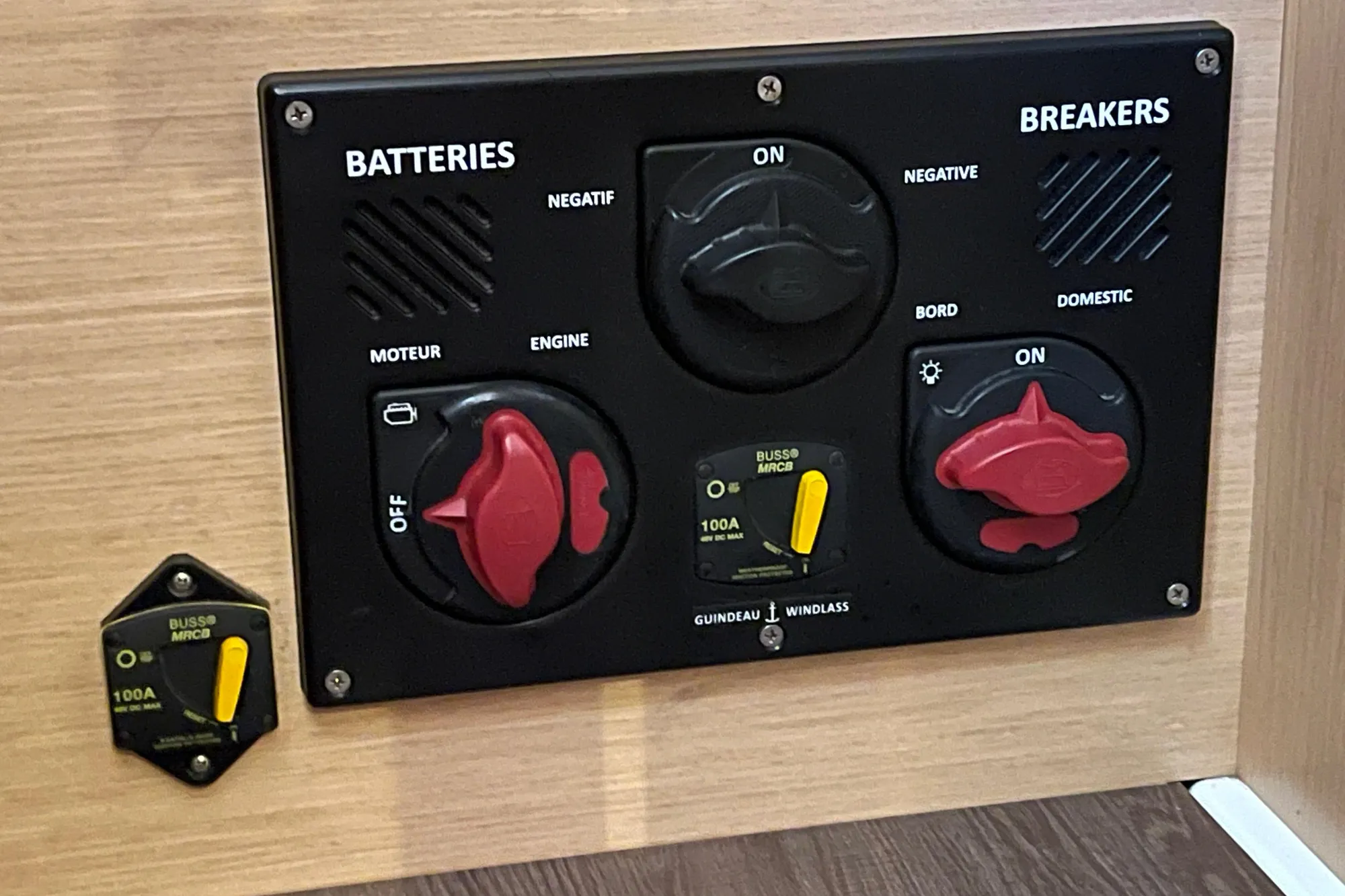 Control panel of a 2015 Beneteau First 235 sailboat with battery and breaker switches.