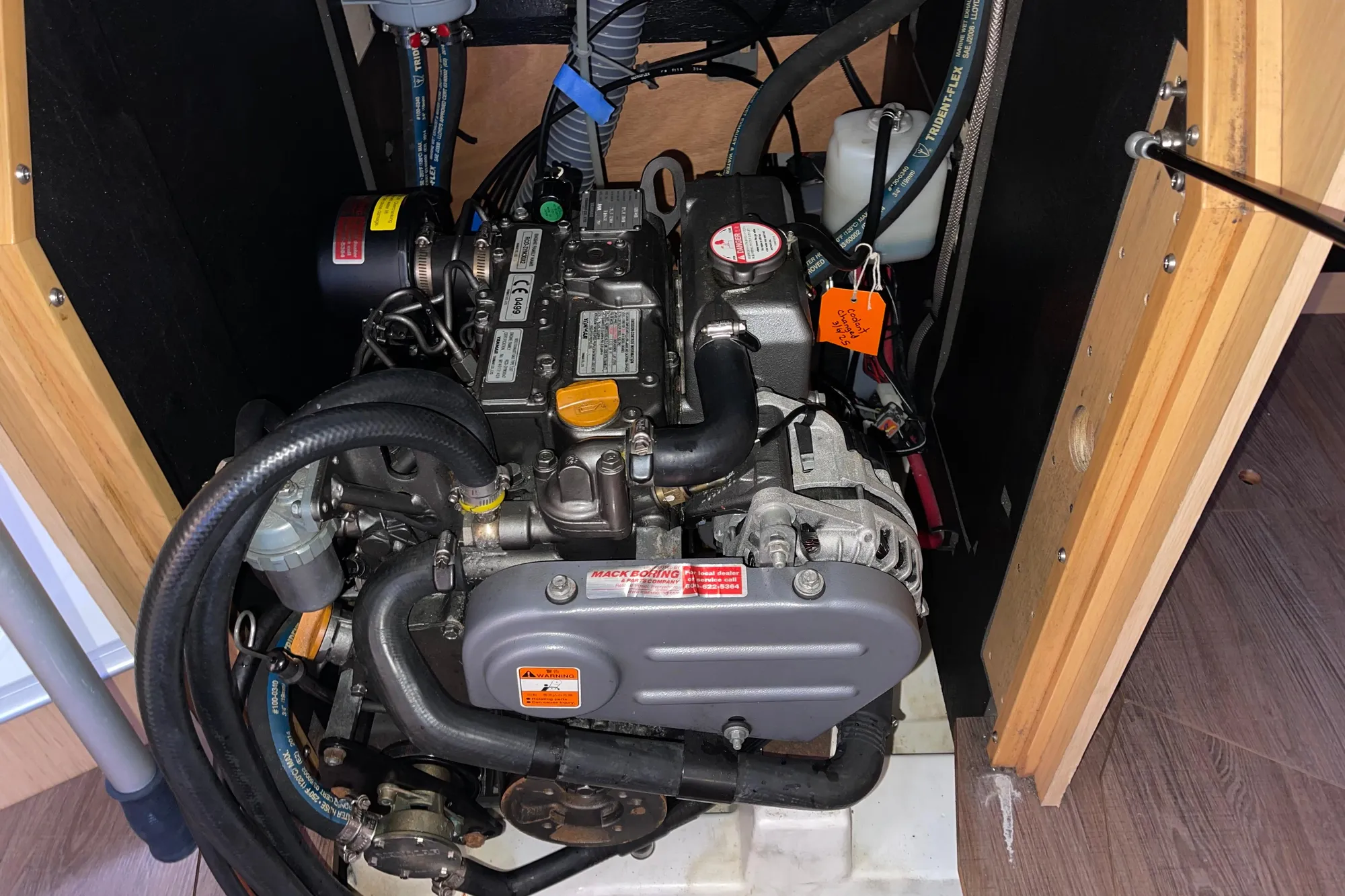 Engine compartment of a 2015 Beneteau First 235 sailboat, showcasing detailed mechanical components.