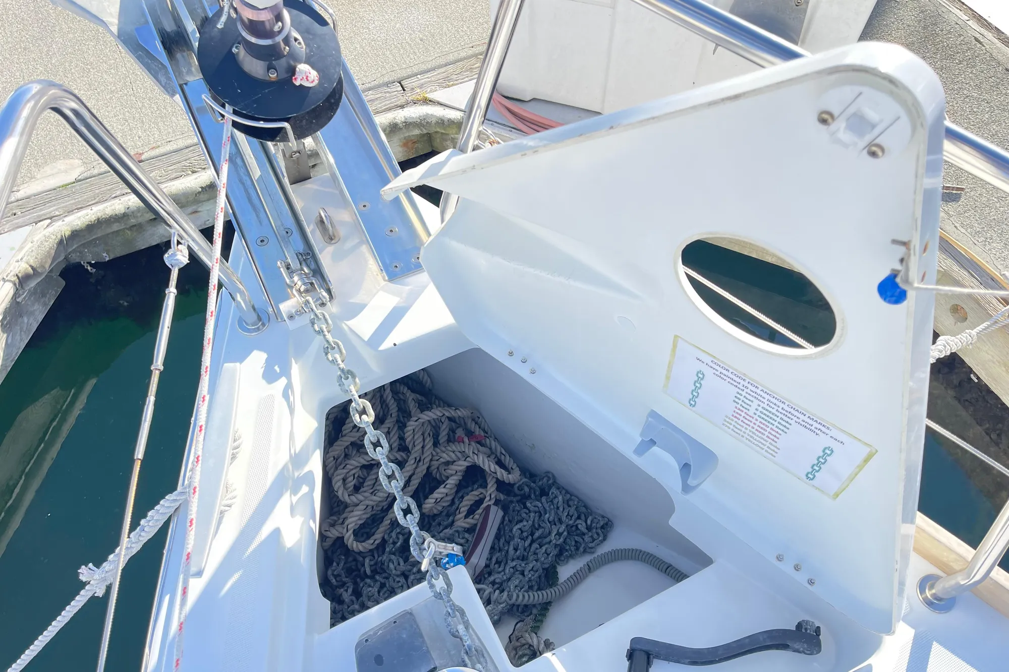 Bow of 2015 Beneteau First 235 sailboat with anchor chain and rope storage.
