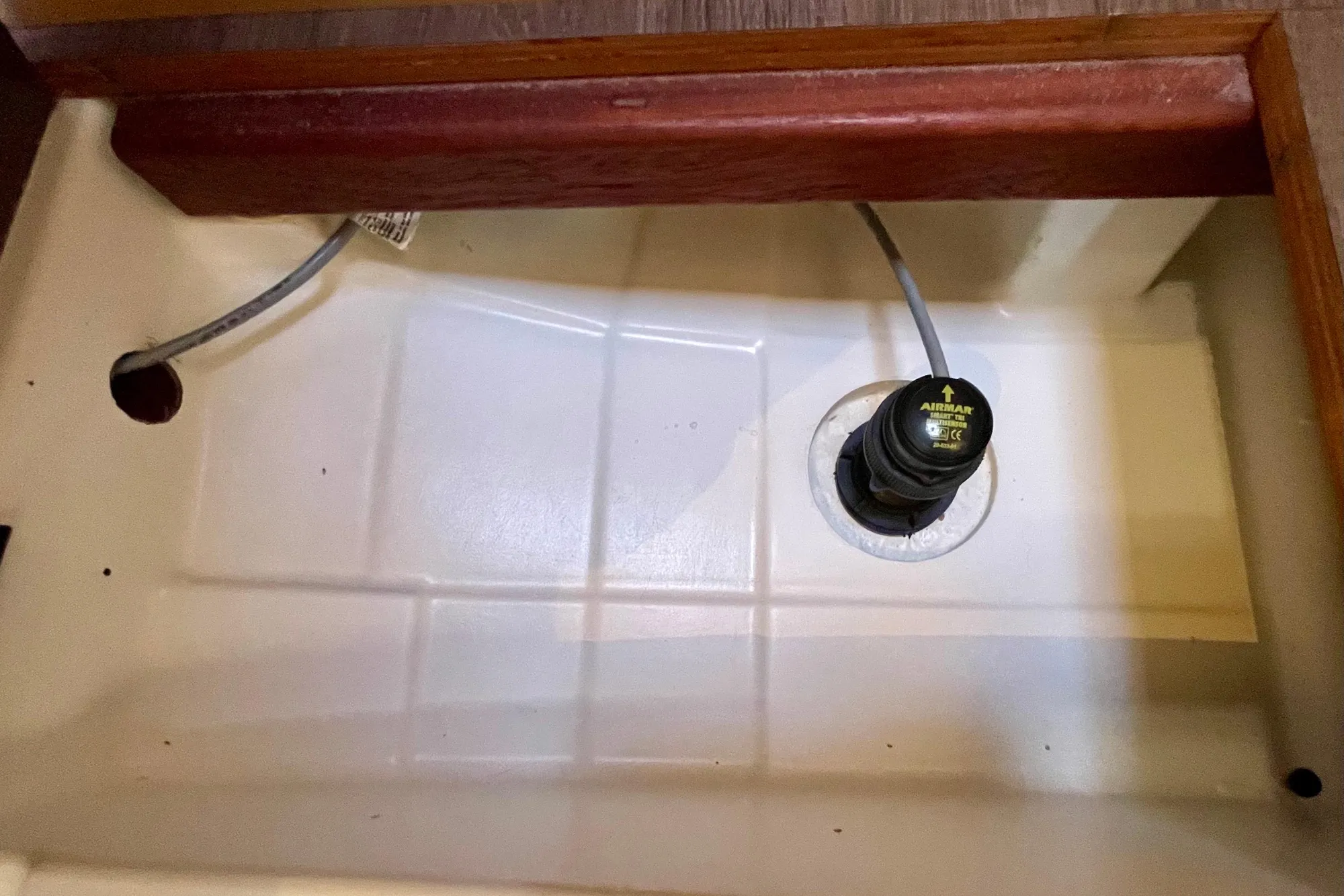 Bilge area of 2015 Beneteau First 235 sailboat with wiring and sensor.