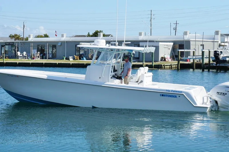  Yacht Photos Pics 2020 Contender 35 ST boat docked in marina, clear blue water, sunny day.