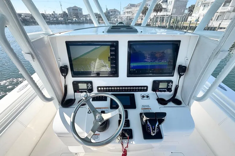  Yacht Photos Pics 2020 Contender 35 ST boat dashboard with dual screens and controls.