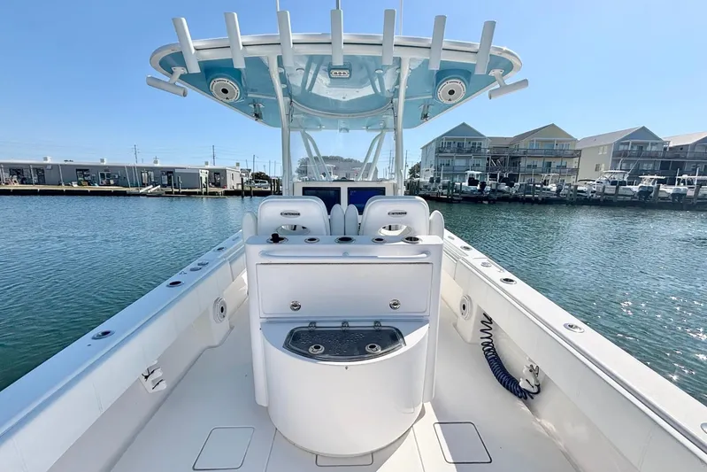  Yacht Photos Pics 2020 Contender 35 ST boat interior with helm station, docked near waterfront buildings.