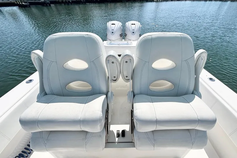  Yacht Photos Pics 2020 Contender 35 ST boat with dual white cushioned seats on a calm water backdrop.