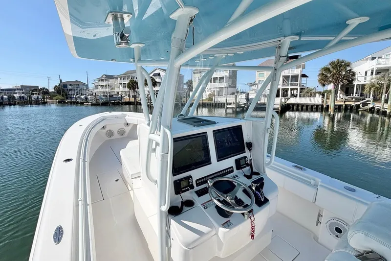  Yacht Photos Pics 2020 Contender 35 ST boat with modern helm, docked in a scenic waterfront area.