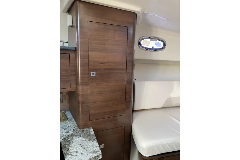  Yacht Photos Pics 2021 Boston Whaler 345 Conquest interior with wood cabinetry and seating.