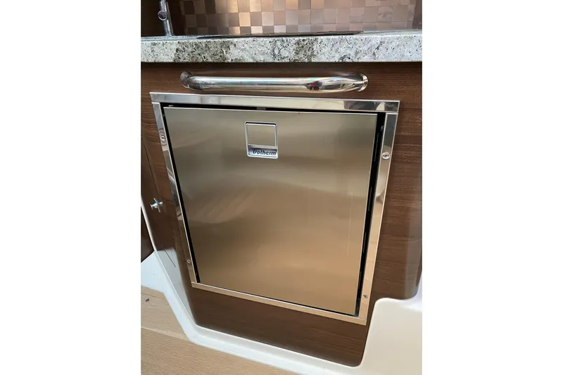  Yacht Photos Pics Stainless steel refrigerator on 2021 Boston Whaler 345 Conquest boat interior.