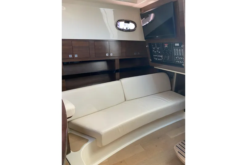  Yacht Photos Pics Interior of 2021 Boston Whaler 345 Conquest with white seating and control panel.