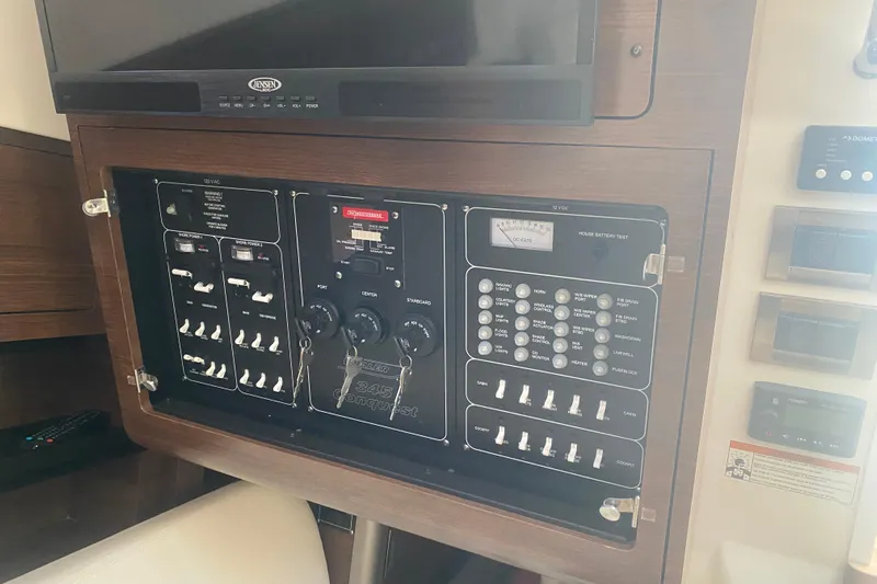  Yacht Photos Pics Control panel of a 2021 Boston Whaler 345 Conquest boat, featuring switches and gauges.