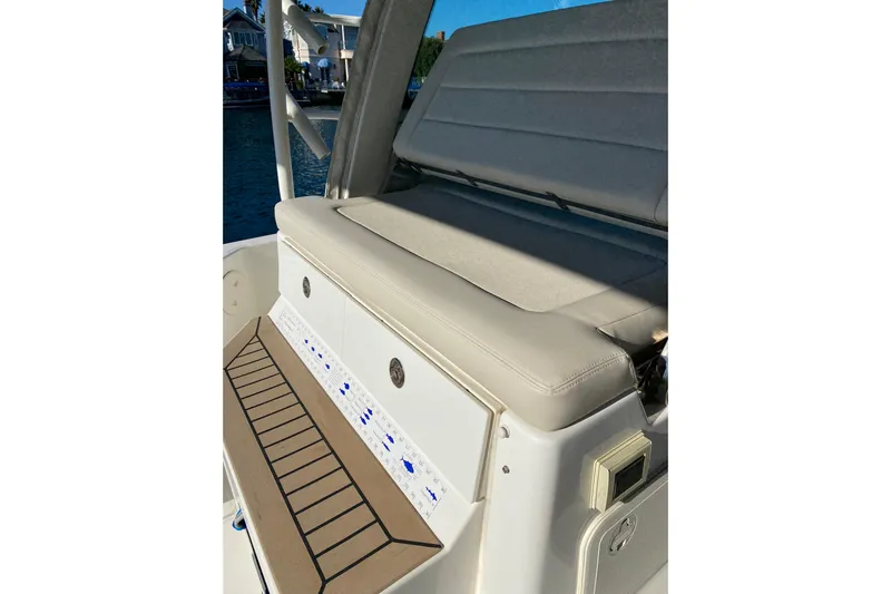  Yacht Photos Pics 2021 Boston Whaler 345 Conquest boat seating area with control panel and cushioned bench.