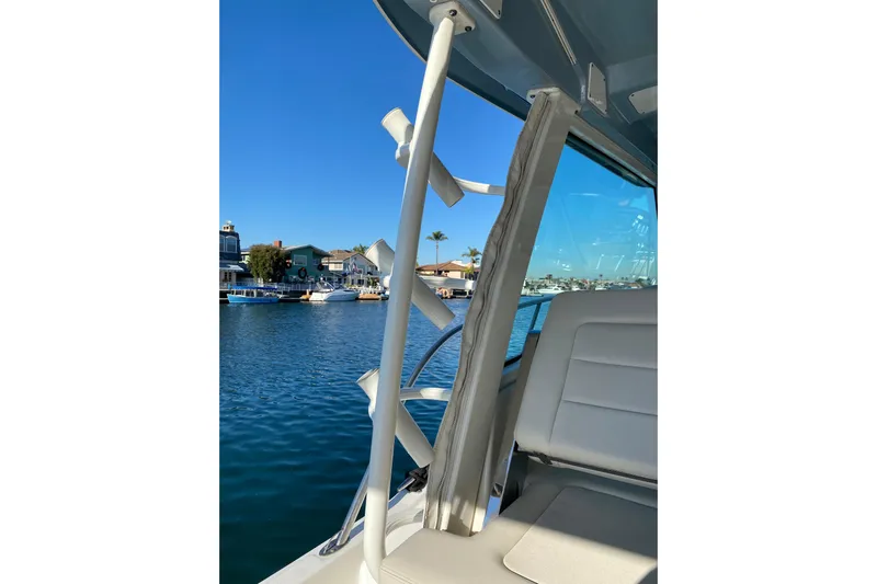  Yacht Photos Pics 2021 Boston Whaler 345 Conquest interior with rod holders, overlooking waterfront homes.