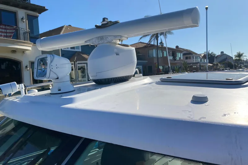 Yacht Photos Pics 2021 Boston Whaler 345 Conquest radar and spotlight on deck, coastal background.