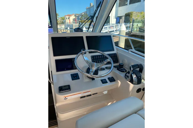  Yacht Photos Pics 2021 Boston Whaler 345 Conquest helm with modern controls and navigation screens.