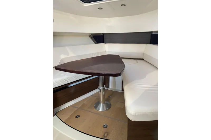  Yacht Photos Pics Interior of 2021 Boston Whaler 345 Conquest with elegant seating and wooden table.