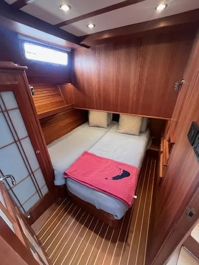 Seventeen Yacht Photos Pics 2021 Sabre 45 Salon Express cabin with wood paneling and cozy bedding.
