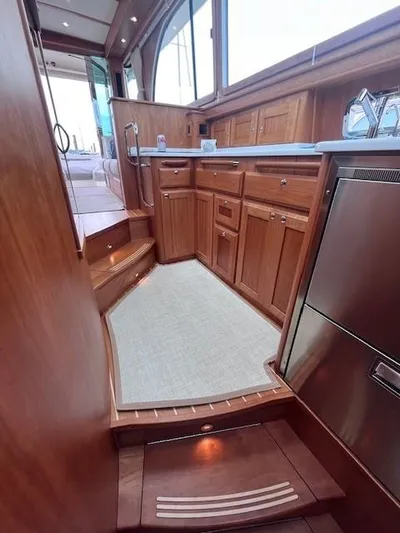 Seventeen Yacht Photos Pics 2021 Sabre 45 Salon Express interior with wooden cabinetry and modern kitchen appliances.
