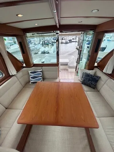 Seventeen Yacht Photos Pics 2021 Sabre 45 Salon Express interior with elegant wood table and plush seating.