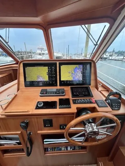 Seventeen Yacht Photos Pics 2021 Sabre 45 Salon Express helm with dual navigation screens and wooden steering wheel.
