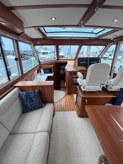 Seventeen Yacht Photos Pics 2021 Sabre 45 Salon Express interior with plush seating and modern helm.