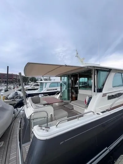 Seventeen Yacht Photos Pics 2021 Sabre 45 Salon Express yacht docked at marina, showcasing sleek design and spacious deck.