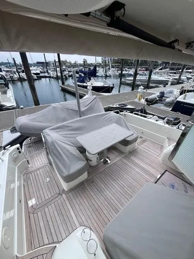 Seventeen Yacht Photos Pics 2021 Sabre 45 Salon Express yacht deck with covered seating at marina.