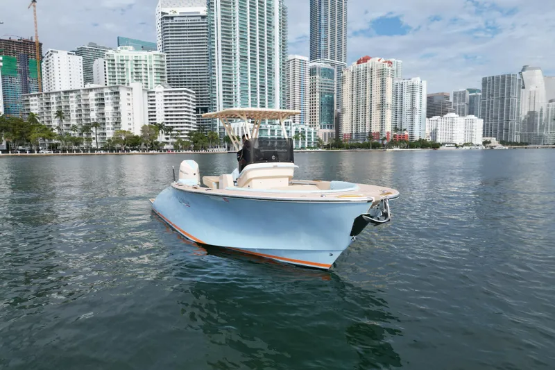  Yacht Photos Pics 2026 Lilybaeum Levanzo 25 Lounge Deck boat on water, city skyline background.