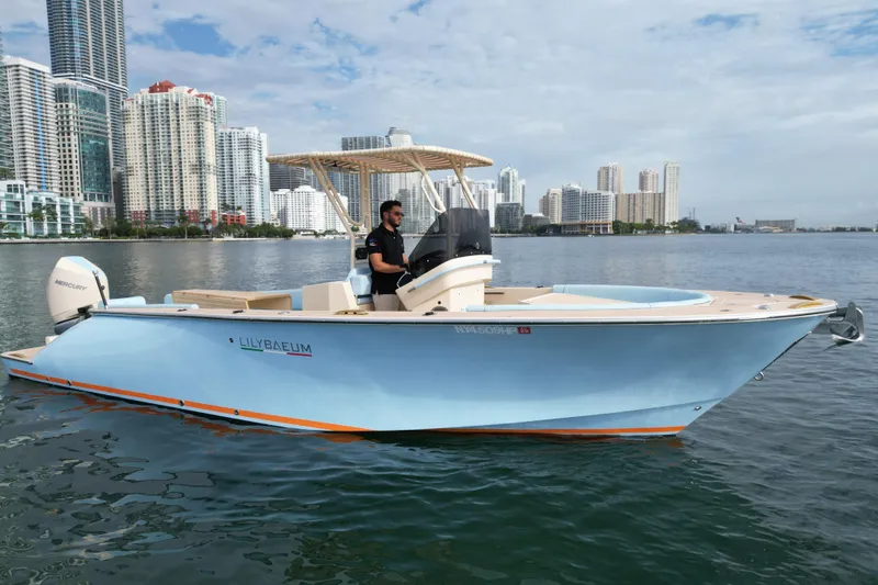  Yacht Photos Pics 2026 Lilybaeum Levanzo 25 Lounge Deck boat on water, city skyline background.