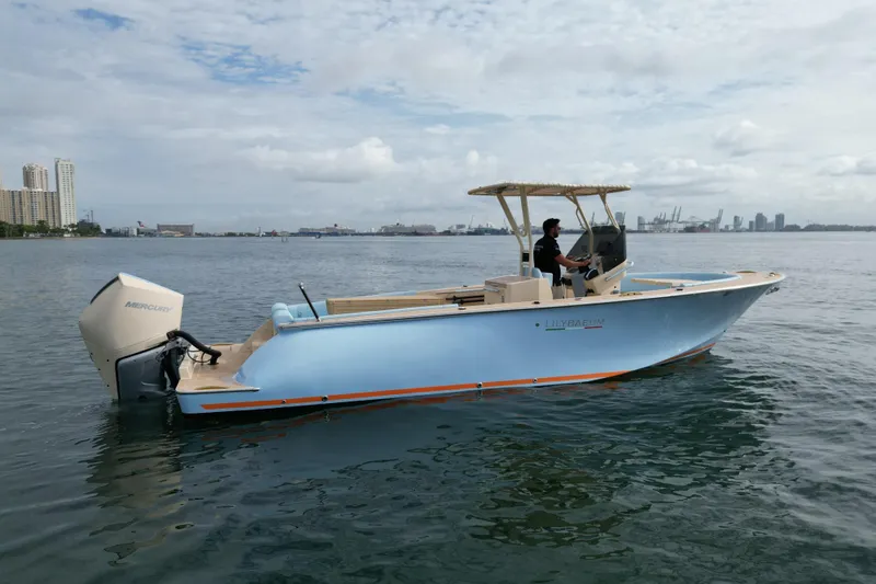  Yacht Photos Pics 2026 Lilybaeum Levanzo 25 Lounge Deck boat on water, city skyline in background.