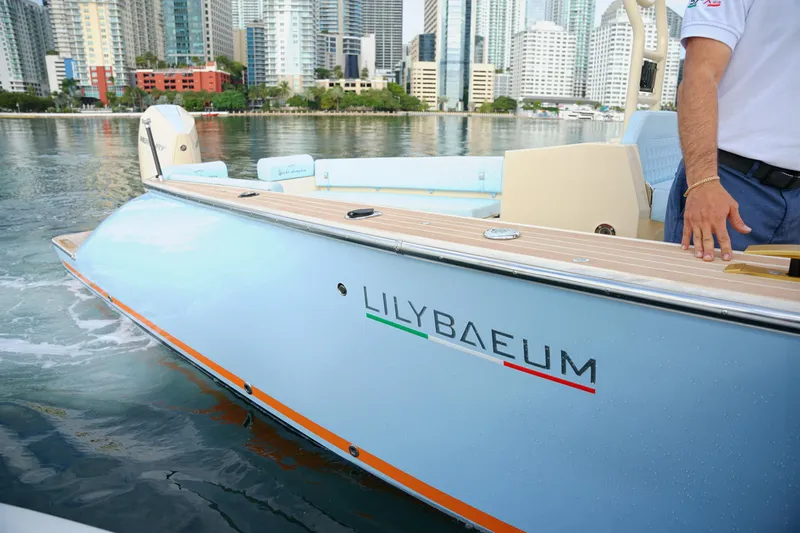  Yacht Photos Pics 2026 Lilybaeum Levanzo 25 Lounge Deck boat on water, city skyline in background.