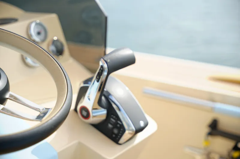  Yacht Photos Pics Close-up of 2026 Lilybaeum Levanzo 25 Lounge Deck steering wheel and throttle controls.