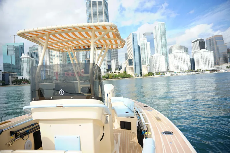  Yacht Photos Pics 2026 Lilybaeum Levanzo 25 Lounge Deck boat cruising near city skyline.