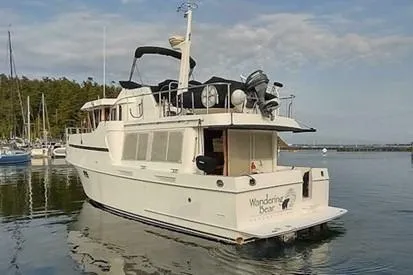 Wandering Bear Yacht Photos Pics 2001 Ocean Alexander Classico yacht docked in serene marina setting.