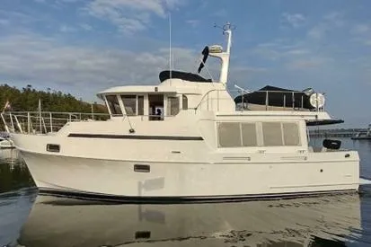 Wandering Bear Yacht Photos Pics 2001 Ocean Alexander Classico yacht on calm water under a blue sky.