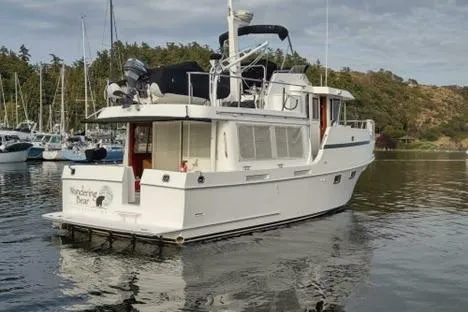 Wandering Bear Yacht Photos Pics 2001 Ocean Alexander Classico yacht docked in a serene marina setting.