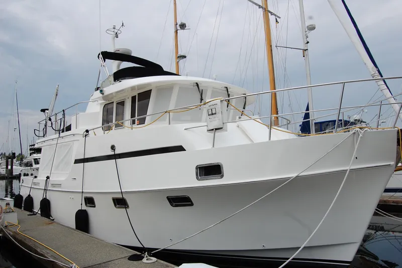 Wandering Bear Yacht Photos Pics 2001 Ocean Alexander Classico yacht docked at marina, showcasing sleek white design.