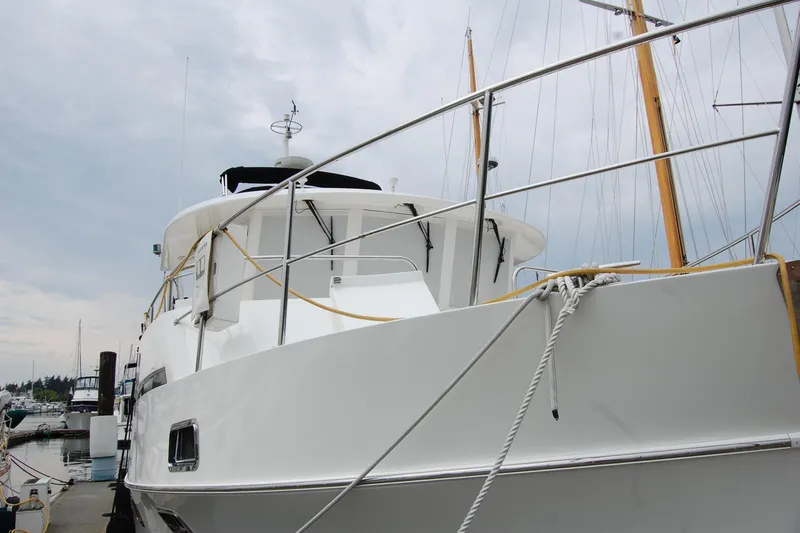 Wandering Bear Yacht Photos Pics 2001 Ocean Alexander Classico yacht docked at marina, showcasing sleek design and sturdy build.