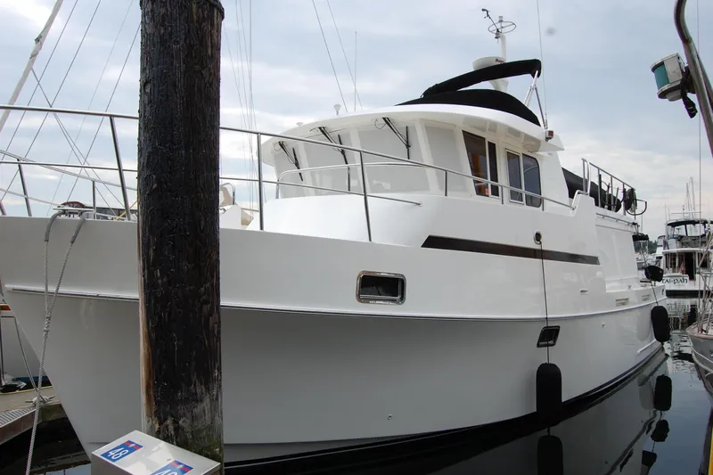 Wandering Bear Yacht Photos Pics 2001 Ocean Alexander Classico yacht docked at marina, side view.