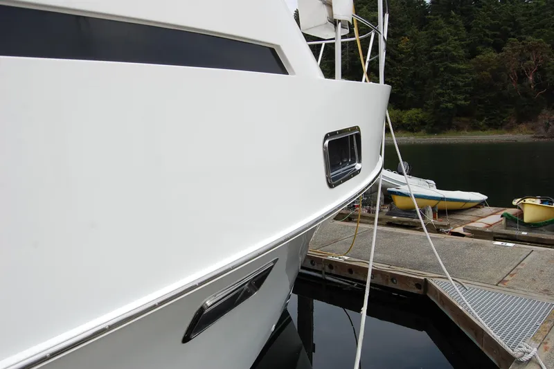 Wandering Bear Yacht Photos Pics 2001 Ocean Alexander Classico yacht docked at a marina with lush forest backdrop.