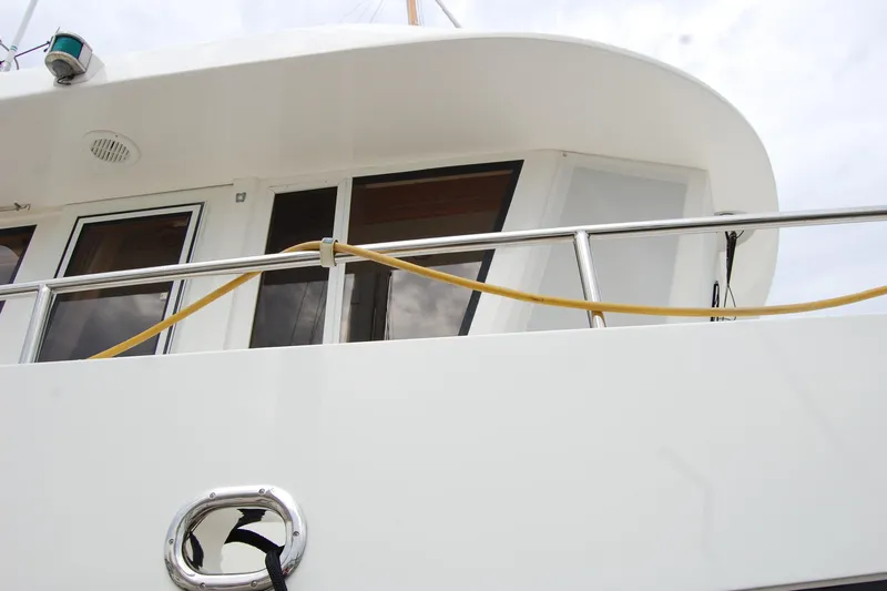 Wandering Bear Yacht Photos Pics 2001 Ocean Alexander Classico yacht exterior with railing and windows.